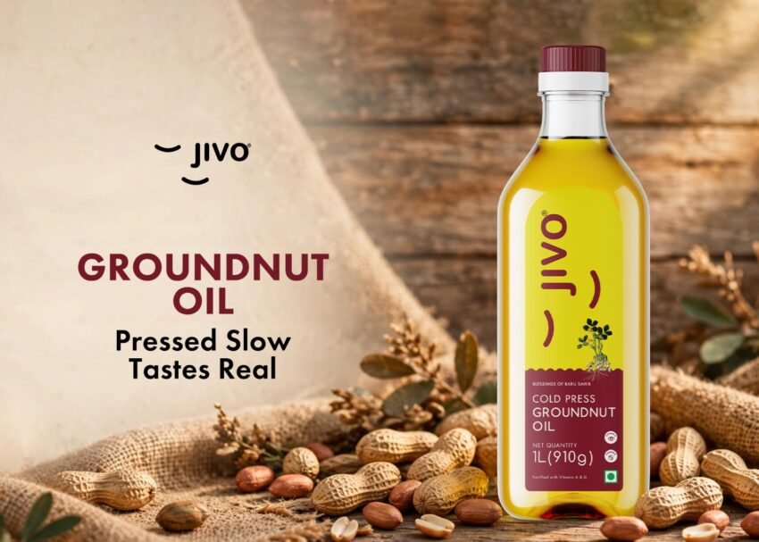 Bottle of best groundnut oil in India placed next to peanuts on a kitchen counter